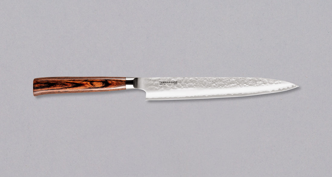 Tamahagane "TSUBAME" Sashimi-Slicer 210mm je izdelan iz VG-5 nerjavečega jekla in ima zelo vzdržljiv in vodoodporen ročaj iz pakka lesa. Izjemno nezahteven in zanesljiv nož, primeren za profesionalne kuharje.