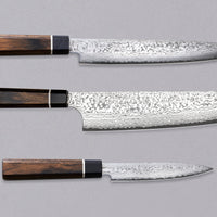 Black Damascus linija je naša linija nožev s 33-slojnim damask vzorcem, zaradi katerega je vsak kos unikaten. Senzo Black Damascus se kuje v kovačiji Suncraft. Ta set je sestavljen iz japonskih kuhinjskih nožev Black Damascus Slicer 210 mm, Black Damascus Bunka 200mm in Black Damascus Utility 120 mm, iz VG-10 jekla.