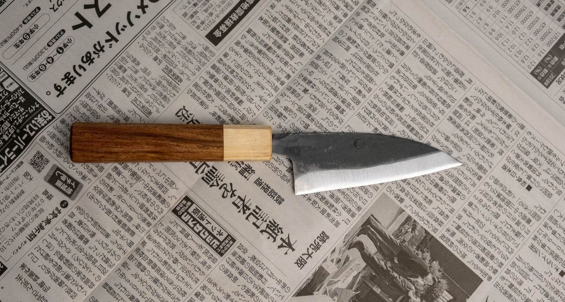 Yoshida Ajikiri SUJ-2 Kuro-uchi 100 mm [Rosewood-Cedar] je tradicionalen japonski nož za filiranje manjših rib. Sredica noža je izdelana iz SUJ-2 jekla, rezilo pa je opremljeno s tradicionalnim japonskim ročajem iz palisandra, ki na vrhu prehaja v zaključni obroček iz lesa cedre. 