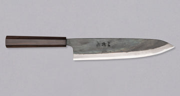 Kokugei Gyuto Aogami #1 Kuro-uchi Ebony 240 mm prikazan z desne strani, s poudarjenim Aogami #1 jeklom in robustnim ročajem iz ebenovine.