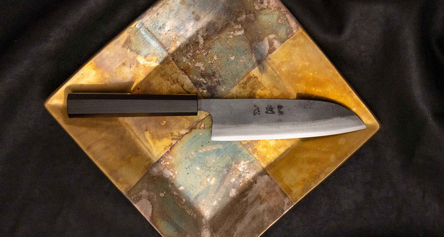 Kokugei Santoku Aogami #1 Kuro-uchi Ebony 165 mm je vsestranski japonski kuhinjski nož, namenjen za pripravo mesa, rib in zelenjave. 