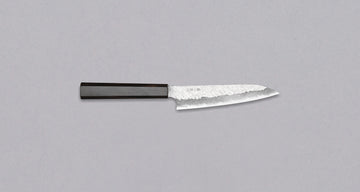 Nigara Petty VG-10 Damascus Tsuchime 150 mm je majhen večnamenski japonski kuhinjski nož, primeren za prostoročna in manjša rezalna opravila, kot so npr. lupljenje in razkoščičevanje. Jedro iz nerjavečega jekla VG-10 zagotavlja dolgotrajno ostrino ter minimalno vzdrževanje. Ima ročaj iz luksuznega lesa ebenovine.