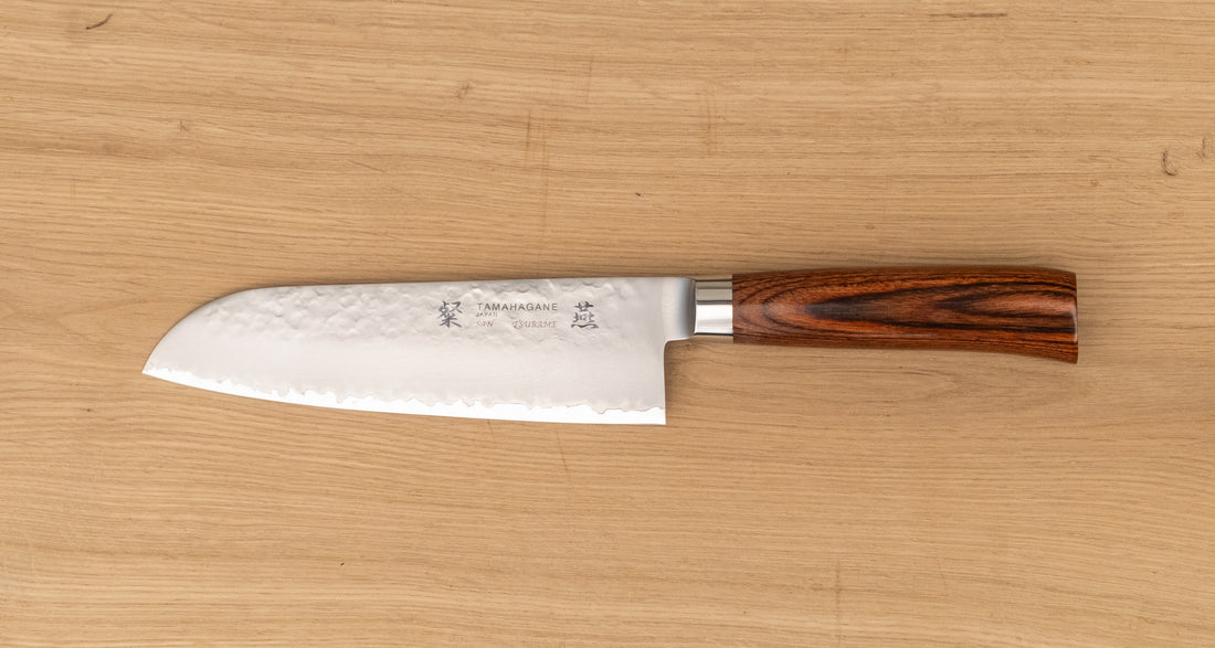 Tamahagane "TSUBAME" Santoku 175 mm je izdelan iz VG-5 nerjavečega jekla in ima ročaj iz pakka lesa v zahodnem stilu. Zanesljiv in nezahteven nož, odličen za profesionalne kuhinje.